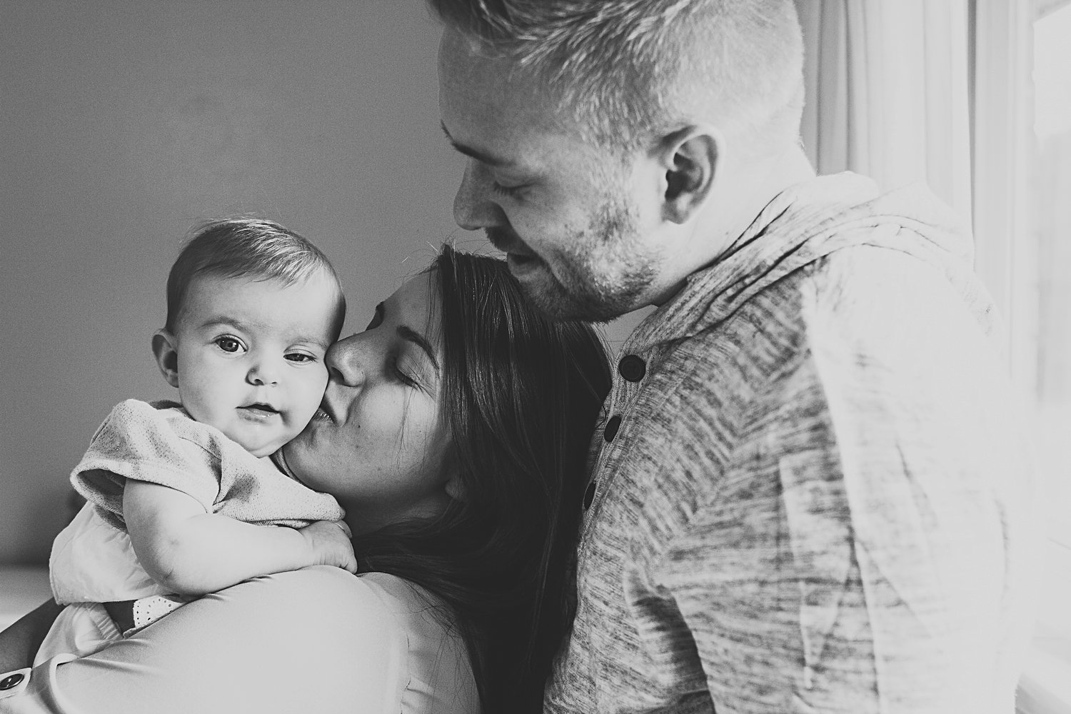 Family portrait of parents with young baby girl