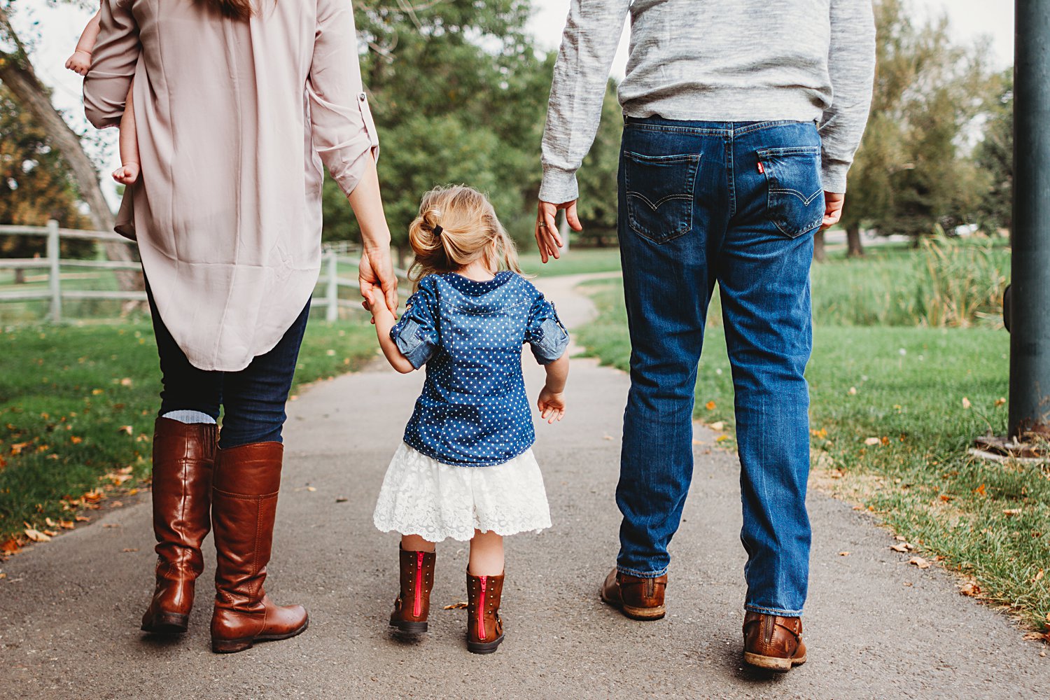 Family portrait with young children walking in park