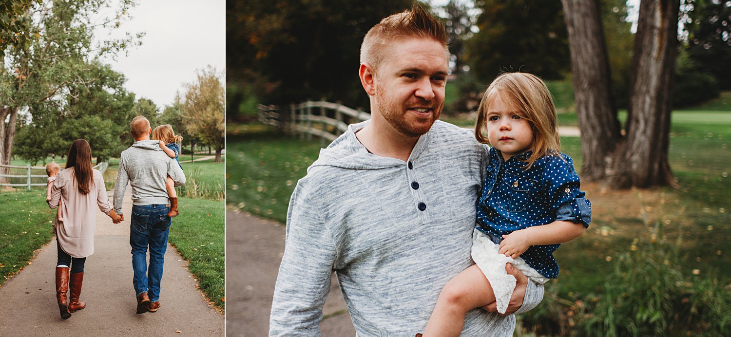 Family portrait of young family walking in park with toddler girls