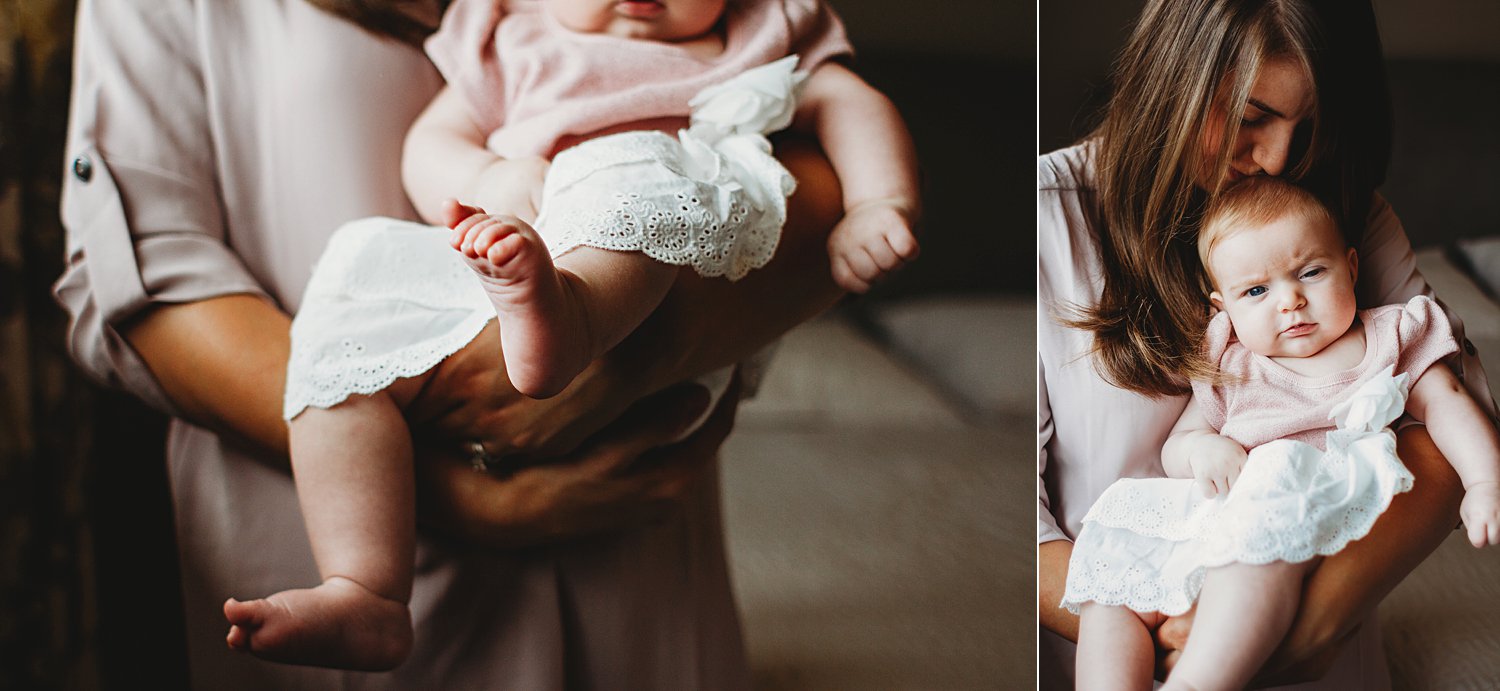 Lifestyle portraits of mom holding baby girl inside