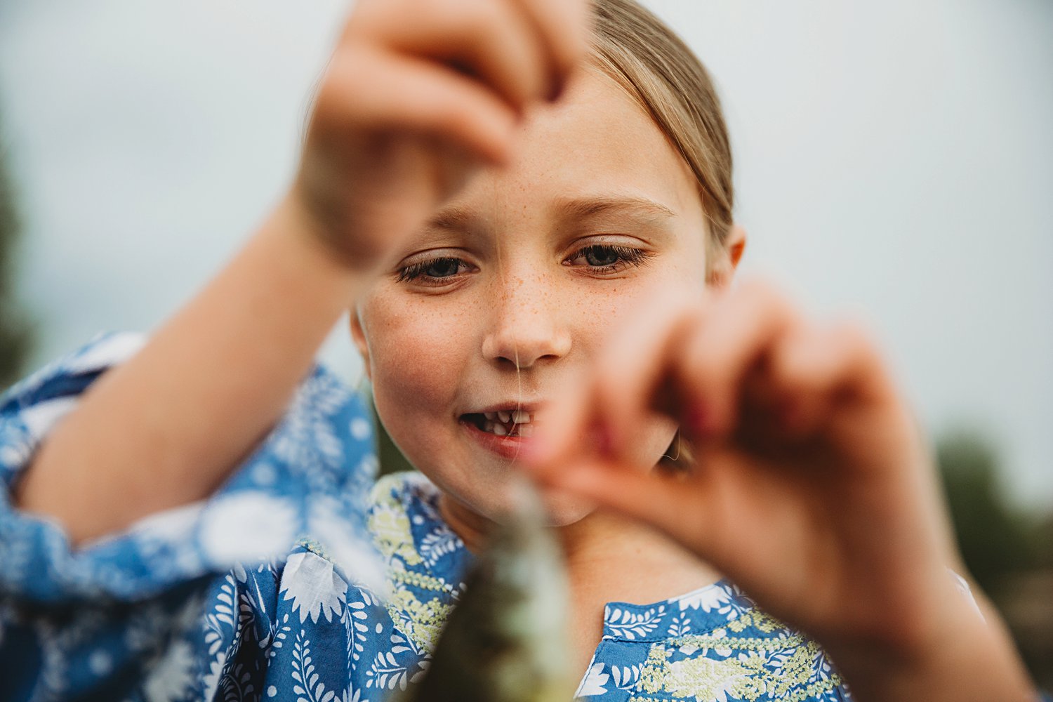Candid portrait of a young girl catching a fish