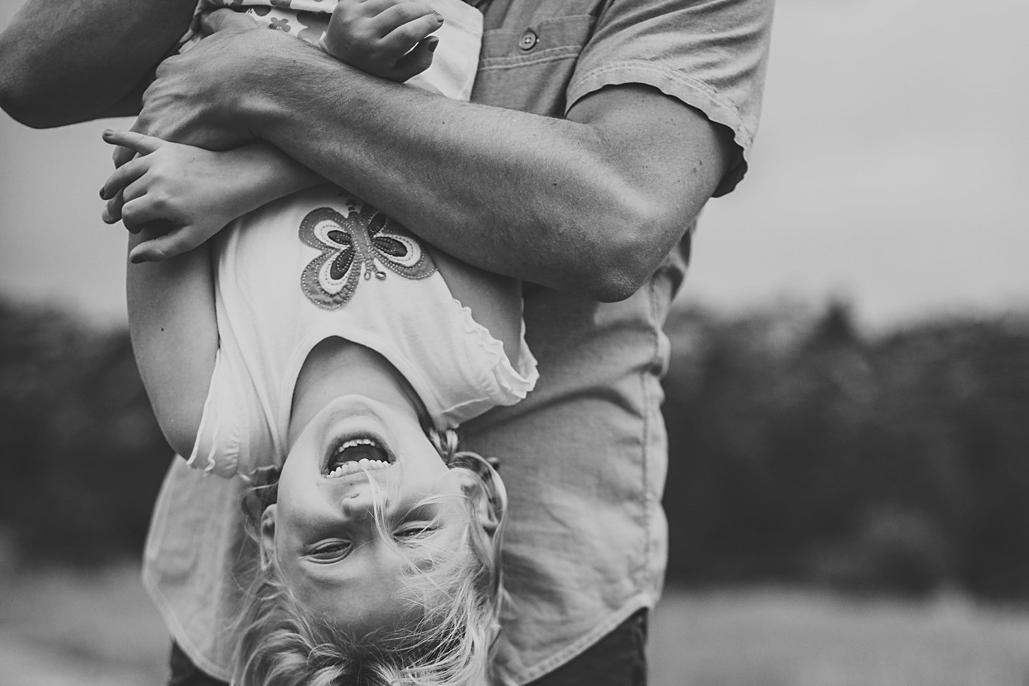 Dad rough playing with daughter