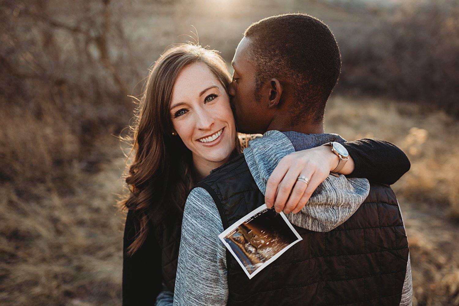 Hugging couple with baby ultrasound