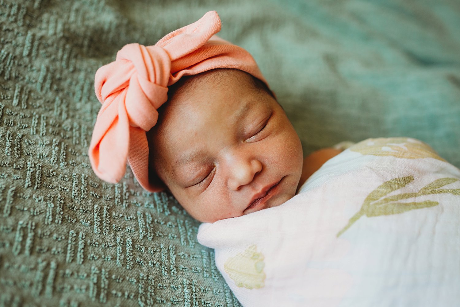 Newborn baby girl wearing headband