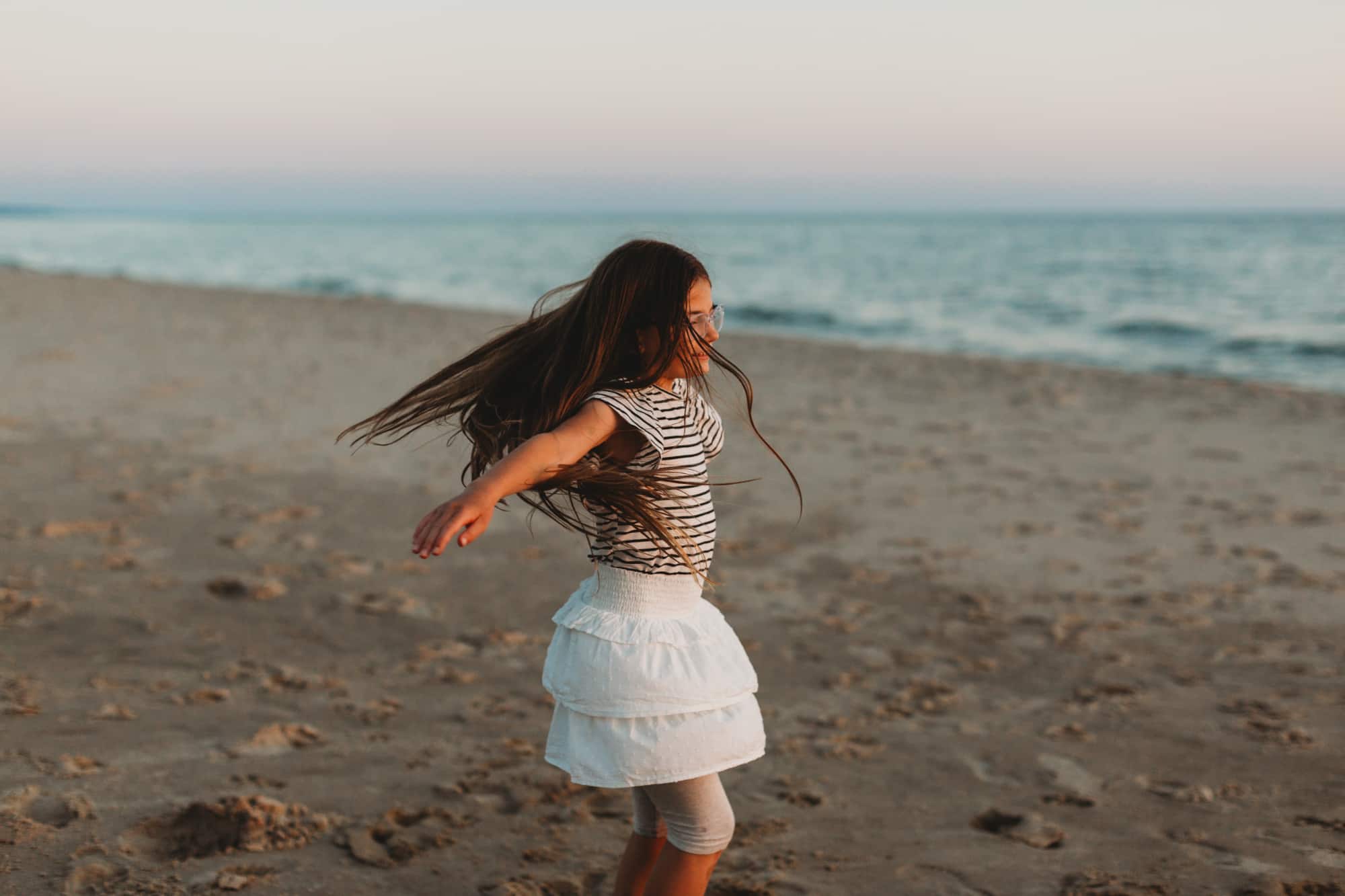 girl playing on lake michigan beach